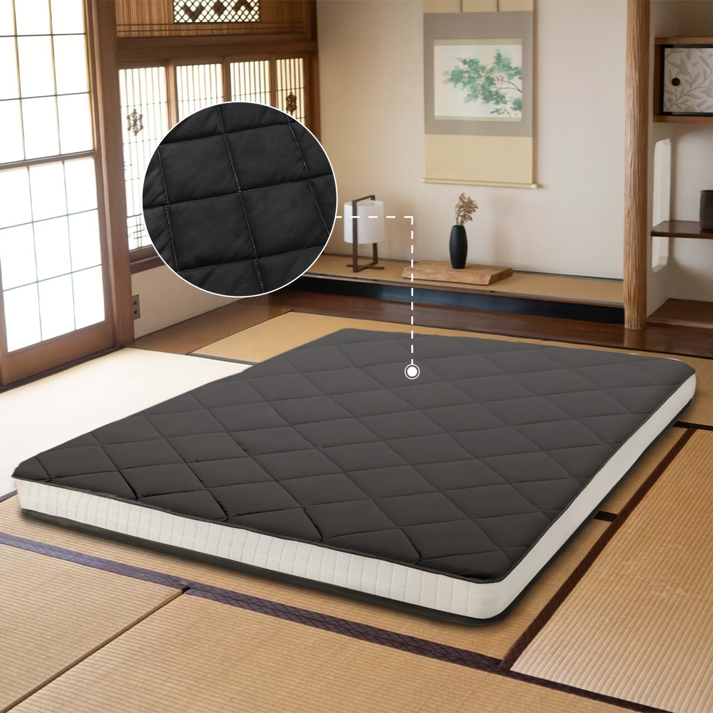 Black mattress pad on a bed in a room with wooden floors and sliding doors.