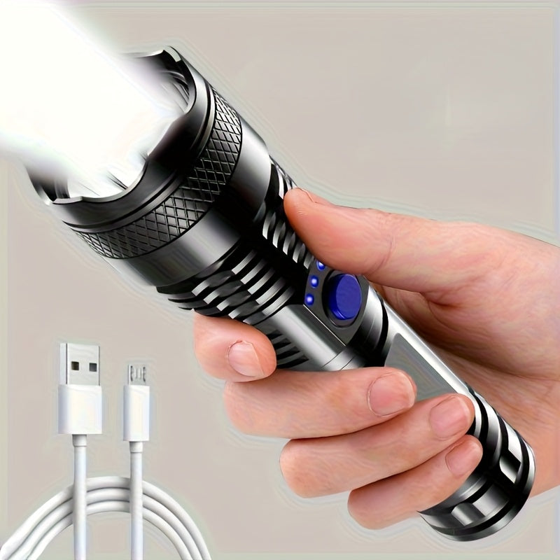 Hand holding a flashlight with USB cable on a neutral background