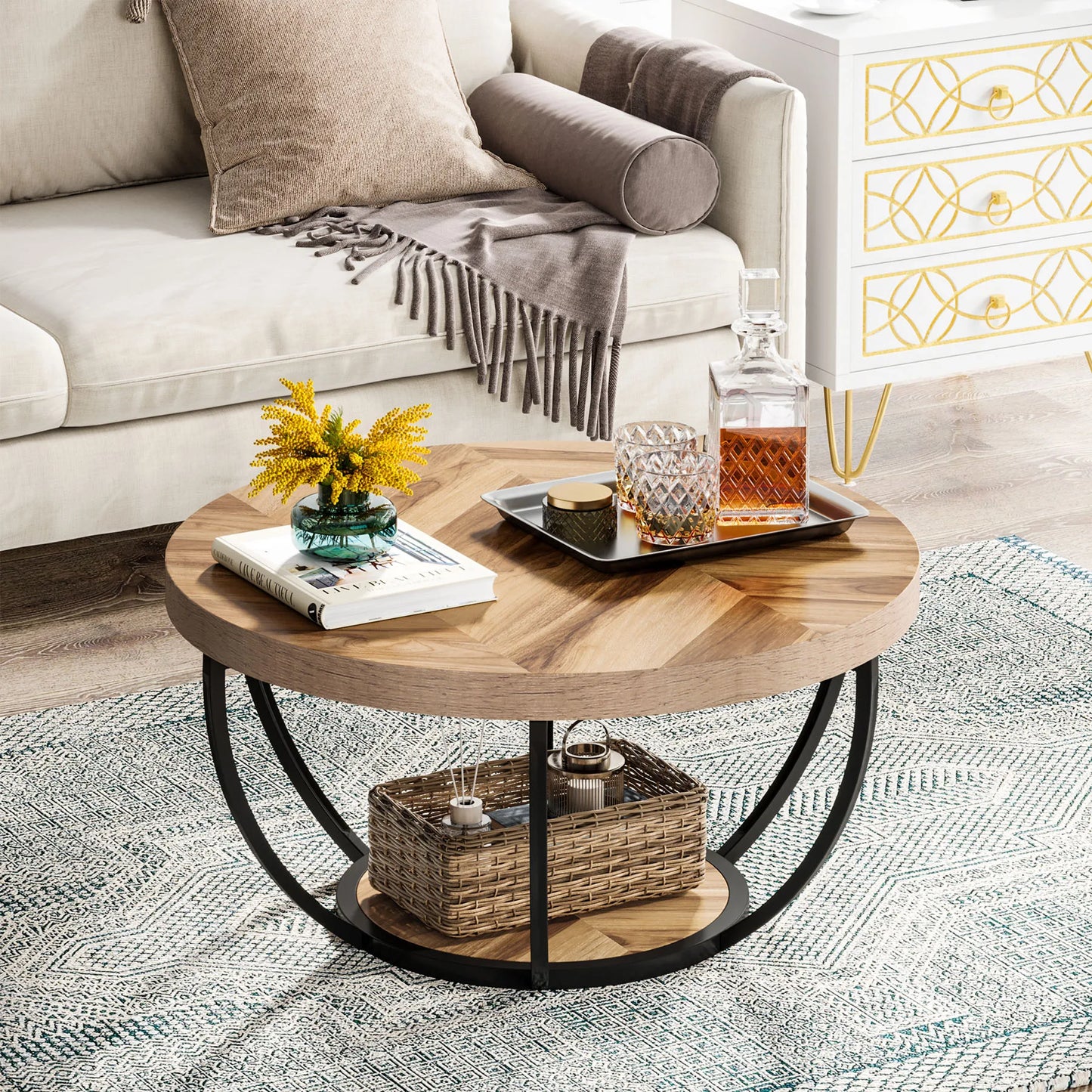 Round coffee table with wood and white finish in modern living room with grey sofa and yellow flowers

