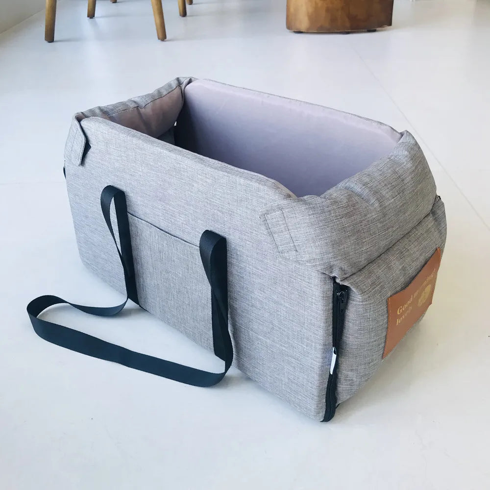 Gray pet carrier with a brown patch on a white floor